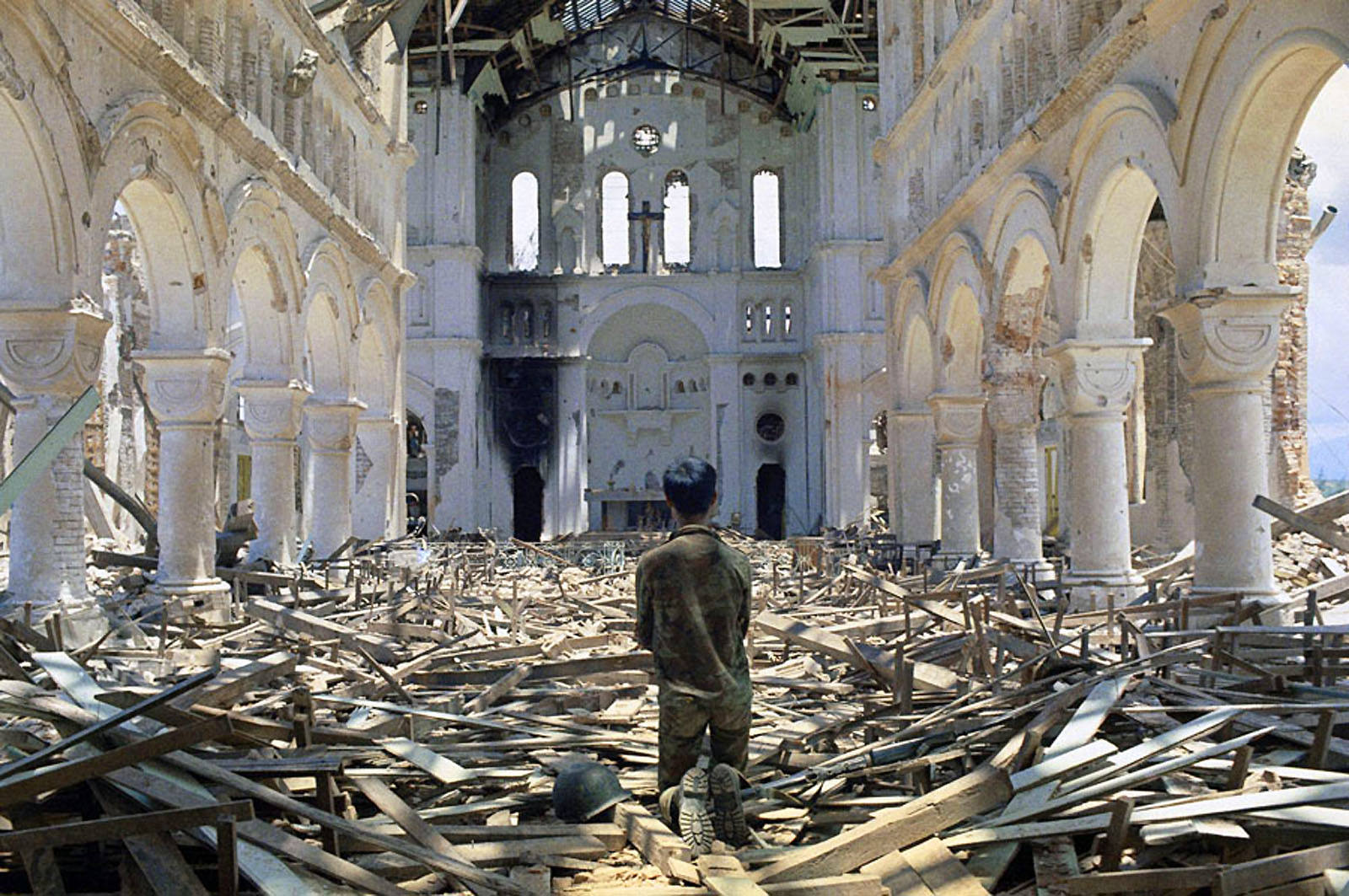 Figure 1: A man praying in a ruined Catholic church in La Vang, a town south of Quang Tri City, Vietnam on July 6, 1972